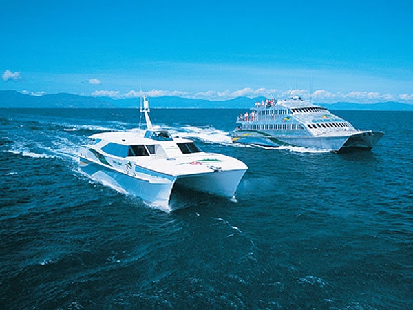 Big Cat Green Island Cruises (left)