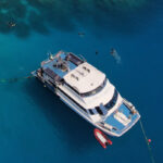 Aerial view of the Reef Experience catamaran with snorkellers on the Great Barrier Reef off Cairns