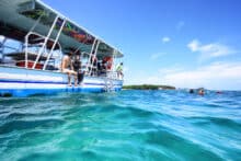 Snorkellers preparing to enter the water from a snorkel tour boat at Green Island.