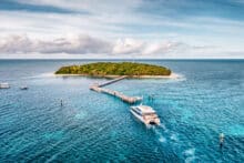 Aerial photo of Green Island with jetty and Great Adventures catamaran approaching.