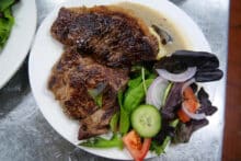 Grilled steak served with mixed salad and dressing on Reef Encounter liveaboard