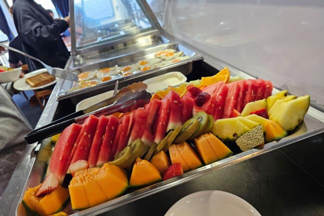 Tropical fruit buffet selection with watermelon, pineapple, and kiwi on OceanQuest Cairns.