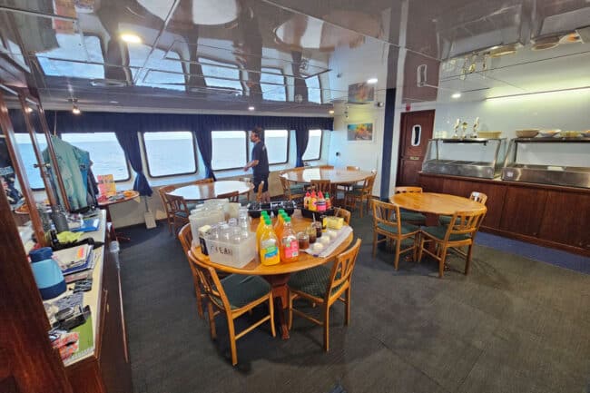 OceanQuest dining area with panoramic ocean views and tables prepared for breakfast service.