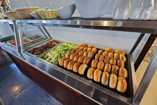 Buffet lunch aboard OceanQuest liveaboard featuring bread rolls, salads & homemade patties.