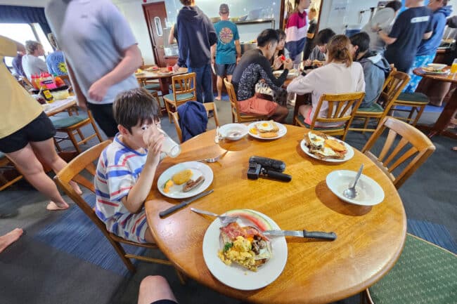 Guests enjoying breakfast aboard OceanQuest liveaboard after an early morning snorkel.