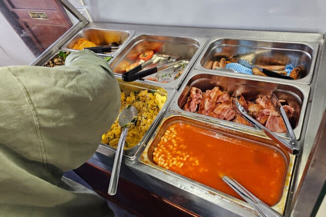 Buffet breakfast aboard OceanQuest featuring bacon, eggs, beans and sausages.