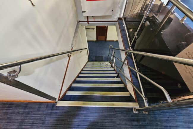 Main internal staircase on OceanQuest connecting upper and lower guest decks.
