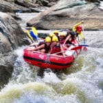 Group of rafters navigating a Grade 2–3 rapid on the Barron River near Cairns, Australia