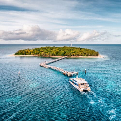 Aerial view of Green Island with the Great Adventures catamaran arriving at the jetty on the Great Barrier Reef.