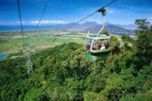 Skyrail gondola overlooking the Cairns coastline and green fields on the Kuranda Day Tour