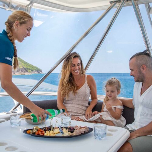 Family enjoying a private lunch onboard Allure luxury yacht on the Great Barrier Reef