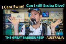 Man wearing scuba gear asking “Can I still scuba dive if I can’t swim?” in Cairns Great Barrier Reef guide