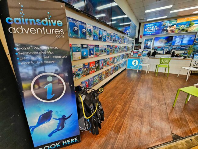 Scuba diving displays and reef tour information inside Cairns Dive Adventures