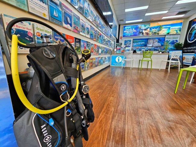 Scuba diving equipment displayed inside Cairns Dive Adventures reef booking centre in Cairns