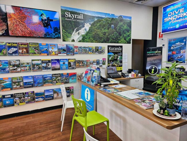 Great Barrier Reef tour booking desk inside Cairns Dive Adventures in Cairns